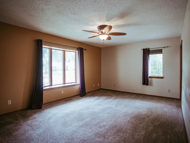 610 25th St SW, Austin, MN 55912 - carpeted spare room featuring a ceiling fan and a textured ceiling