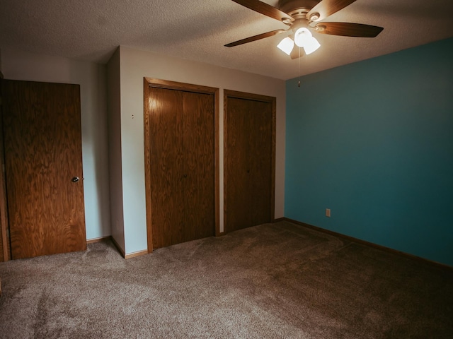 610 25th St SW, Austin, MN 55912 - unfurnished bedroom featuring carpet, multiple closets, a textured ceiling, and ceiling fan
