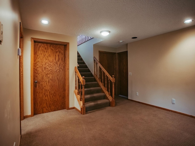610 25th St SW, Austin, MN 55912 - finished basement with carpet, recessed lighting, stairs, and a textured ceiling