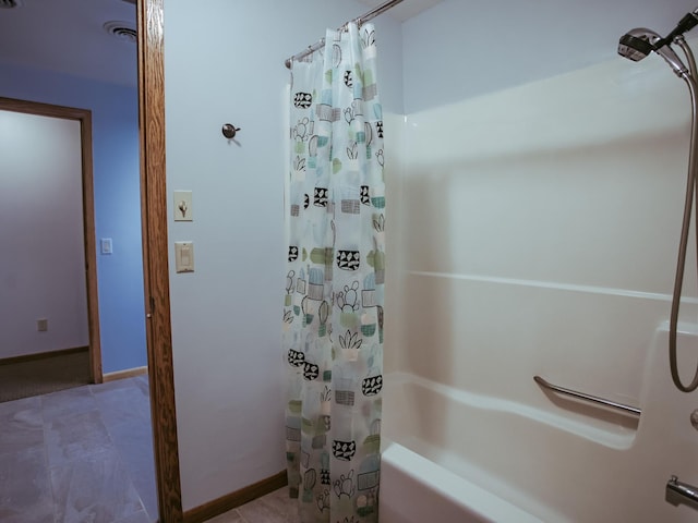 610 25th St SW, Austin, MN 55912 - bathroom featuring shower / bathtub combination with curtain and baseboards
