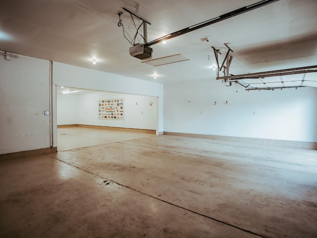 610 25th St SW, Austin, MN 55912 - garage with a garage door opener and baseboards