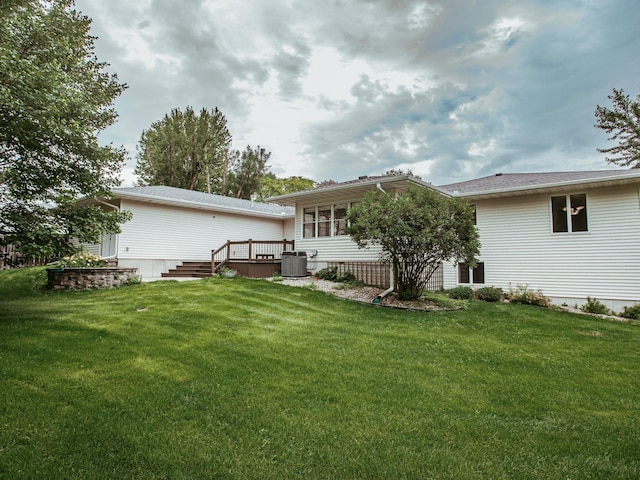 610 25th St SW, Austin, MN 55912 - rear view of house with a lawn and a deck