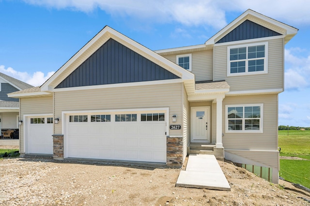 2627 Arbor Dr, Buffalo, MN 55313 - view of front of property with board and batten siding, a garage, and stone siding