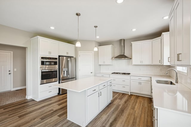 2627 Arbor Dr, Buffalo, MN 55313 - kitchen with stainless steel appliances, wall chimney exhaust hood, a center island, decorative backsplash, and light countertops