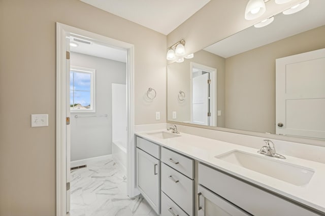 2627 Arbor Dr, Buffalo, MN 55313 - full bath featuring marble look tile flooring, double vanity, and a bath