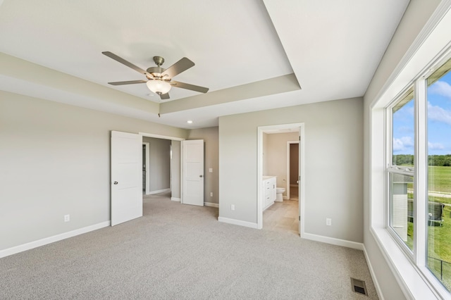 2627 Arbor Dr, Buffalo, MN 55313 - unfurnished bedroom featuring multiple windows, light colored carpet, ensuite bath, and ceiling fan
