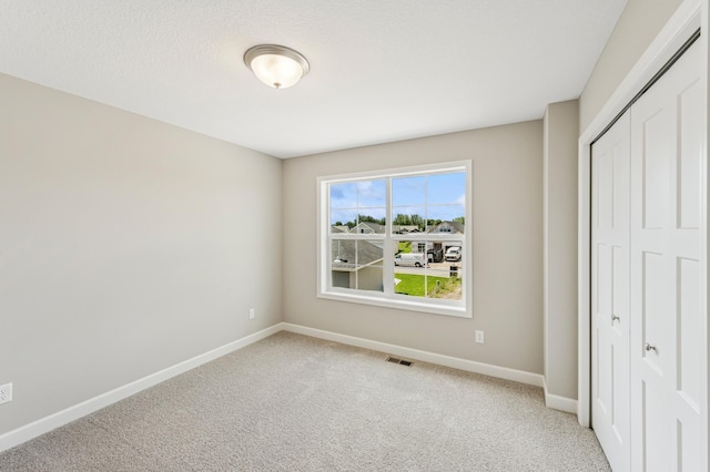 2627 Arbor Dr, Buffalo, MN 55313 - unfurnished bedroom featuring a closet and light colored carpet