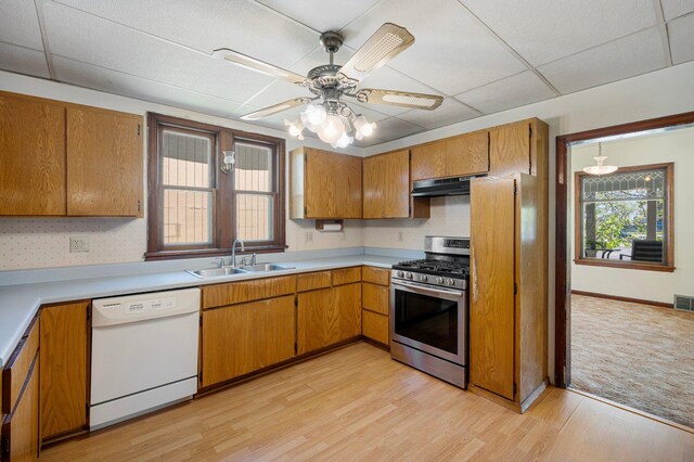 431 19 1/2 Ave N, Saint Cloud, MN 56303 - kitchen featuring white dishwasher, gas range, under cabinet range hood, brown cabinets, and light wood-type flooring