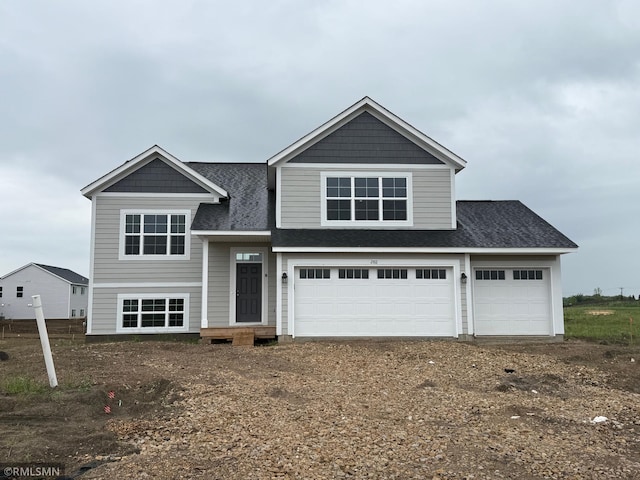 2811 Ivory Ave NE, Saint Michael, MN 55330 - view of front facade with a shingled roof, dirt driveway, and an attached garage