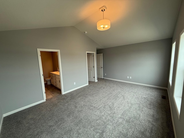 2811 Ivory Ave NE, Saint Michael, MN 55330 - unfurnished bedroom featuring lofted ceiling, dark carpet, and connected bathroom