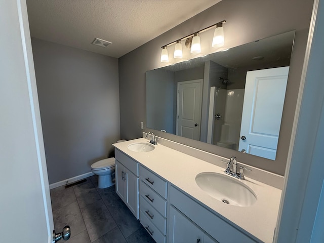 2811 Ivory Ave NE, Saint Michael, MN 55330 - bathroom with double vanity, a shower, tile patterned floors, and a textured ceiling