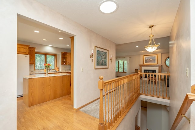 508 Woodside Ct, Shakopee, MN 55379 - hall featuring an upstairs landing, light wood-type flooring, healthy amount of natural light, and recessed lighting