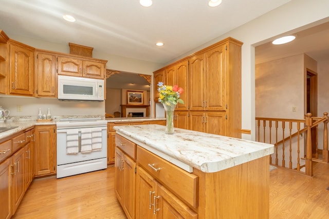 508 Woodside Ct, Shakopee, MN 55379 - kitchen with white appliances, light wood finished floors, a kitchen island, recessed lighting, and brown cabinetry