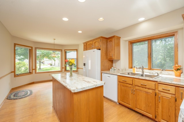 508 Woodside Ct, Shakopee, MN 55379 - kitchen featuring white appliances, a center island, light wood finished floors, recessed lighting, and light stone countertops