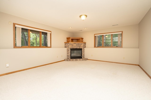 508 Woodside Ct, Shakopee, MN 55379 - unfurnished living room featuring healthy amount of natural light, carpet, and a fireplace
