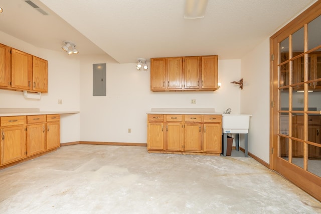 508 Woodside Ct, Shakopee, MN 55379 - kitchen featuring electric panel, unfinished concrete flooring, light countertops, and brown cabinetry