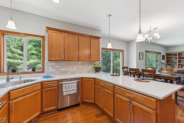 13725 Maxwell Rd, Chisago Lake Twp, MN 55013 - kitchen featuring stainless steel dishwasher, a peninsula, dark wood-style floors, light countertops, and brown cabinets