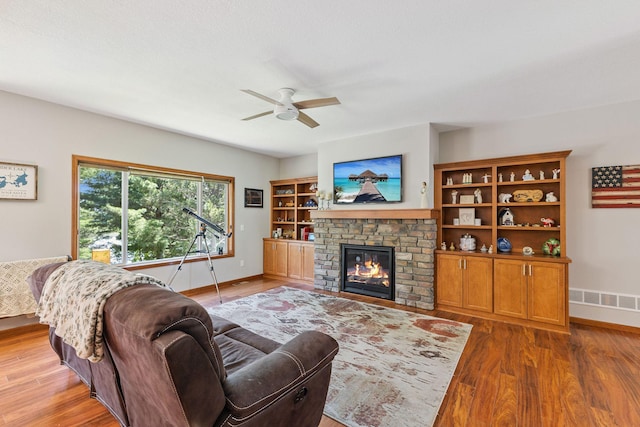 13725 Maxwell Rd, Chisago Lake Twp, MN 55013 - living room with wood finished floors, a ceiling fan, and a glass covered fireplace