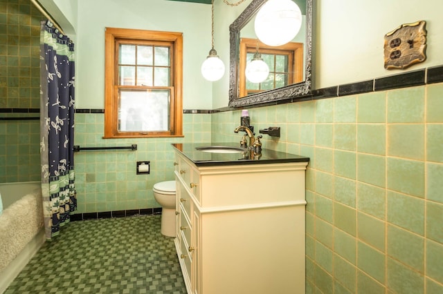210 1st Ave SW, Glenwood, MN 56334 - bathroom featuring tile walls, vanity, tile patterned floors, wainscoting, and shower / bath combo