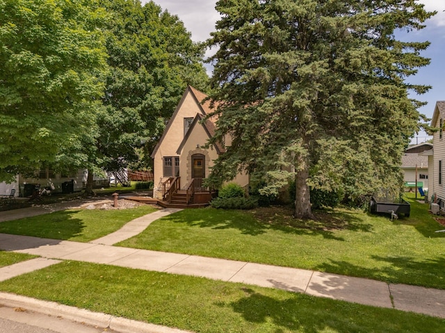 210 1st Ave SW, Glenwood, MN 56334 - tudor home with a front yard and stucco siding