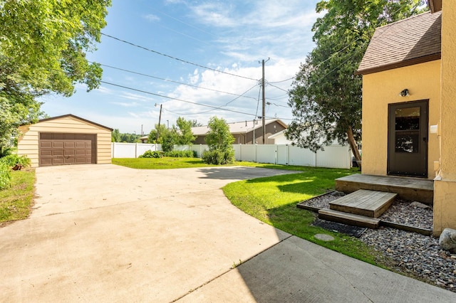 210 1st Ave SW, Glenwood, MN 56334 - view of yard with an outdoor structure, driveway, and a detached garage