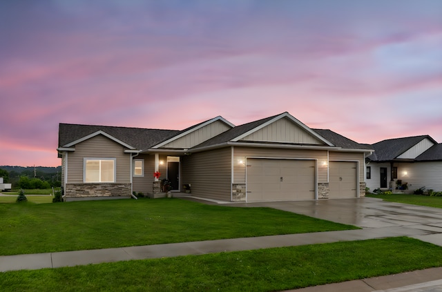 1427 Amco Dr SE, Chatfield, MN 55923 - view of front of property featuring a garage, stone siding, driveway, a front yard, and board and batten siding