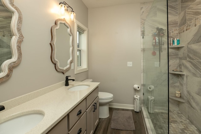 1427 Amco Dr SE, Chatfield, MN 55923 - bathroom with tiled shower, double vanity, and wood finished floors