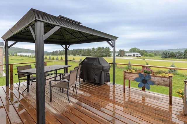 1427 Amco Dr SE, Chatfield, MN 55923 - wooden terrace featuring a gazebo, a grill, outdoor dining area, and a yard