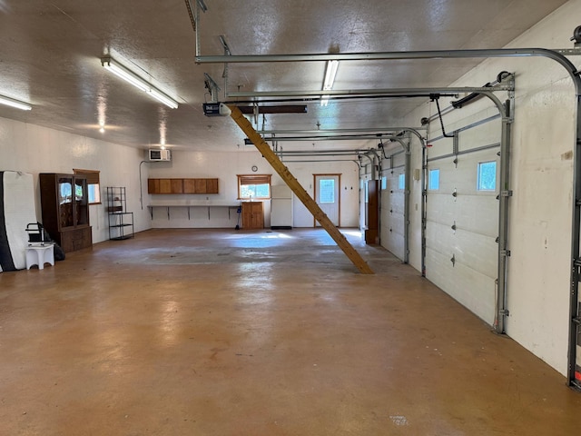 20247 410th Ave, Mickinock Twp, MN 56751 - garage featuring a garage door opener and a wall mounted air conditioner