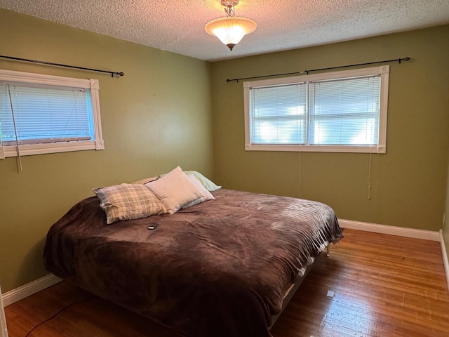 20247 410th Ave, Mickinock Twp, MN 56751 - bedroom featuring a textured ceiling and wood finished floors