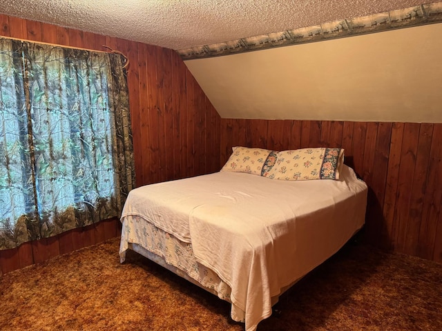 20247 410th Ave, Mickinock Twp, MN 56751 - bedroom with wood walls, carpet floors, lofted ceiling, and a textured ceiling