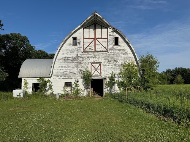 20247 410th Ave, Mickinock Twp, MN 56751 - rear view of house featuring a barn, a gambrel roof, and an outbuilding