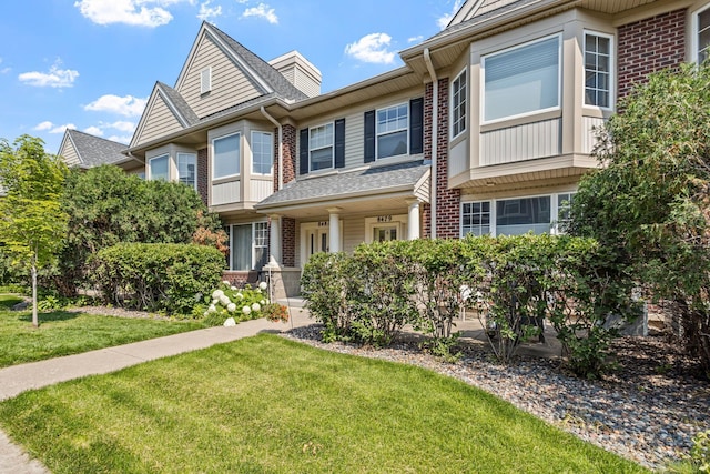 8479 Forestview Ln N, Maple Grove, MN 55369 - townhome / multi-family property with brick siding and a front yard