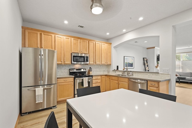 8479 Forestview Ln N, Maple Grove, MN 55369 - kitchen with appliances with stainless steel finishes, light brown cabinets, light wood-style flooring, recessed lighting, and backsplash