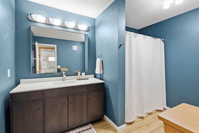 8479 Forestview Ln N, Maple Grove, MN 55369 - full bathroom featuring wood finished floors, a textured ceiling, vanity, and a shower with curtain