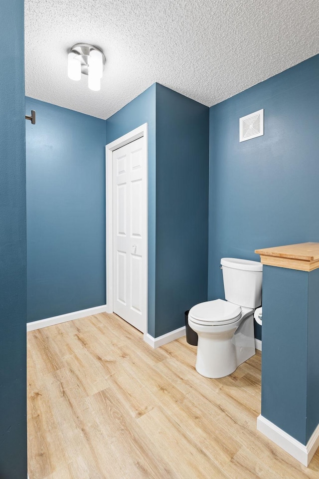 8479 Forestview Ln N, Maple Grove, MN 55369 - bathroom with wood finished floors and a textured ceiling