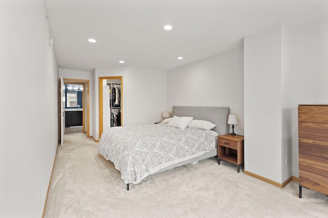 8479 Forestview Ln N, Maple Grove, MN 55369 - bedroom with light carpet, recessed lighting, a walk in closet, and a closet