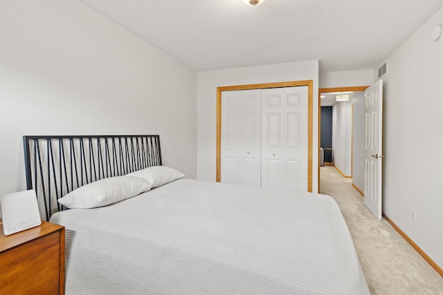 8479 Forestview Ln N, Maple Grove, MN 55369 - bedroom featuring light carpet, a closet, and a textured ceiling