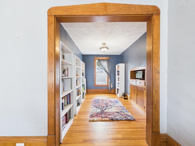 905 3rd Ave SW, Pine City, MN 55063 - corridor featuring light wood-style flooring and a textured ceiling