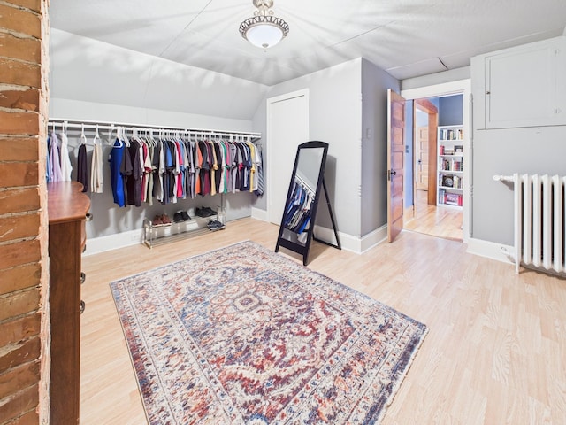 905 3rd Ave SW, Pine City, MN 55063 - walk in closet featuring radiator, wood finished floors, and lofted ceiling