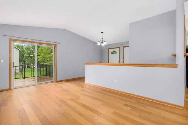 1110 Lilac Ct, Waconia, MN 55387 - unfurnished room with light wood-type flooring, a chandelier, and lofted ceiling