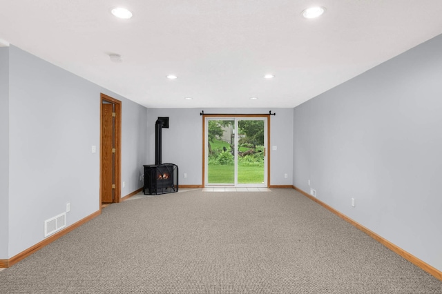 1110 Lilac Ct, Waconia, MN 55387 - unfurnished living room featuring a wood stove, recessed lighting, and light colored carpet
