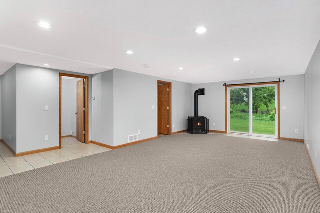1110 Lilac Ct, Waconia, MN 55387 - unfurnished living room with a wood stove, recessed lighting, and light carpet