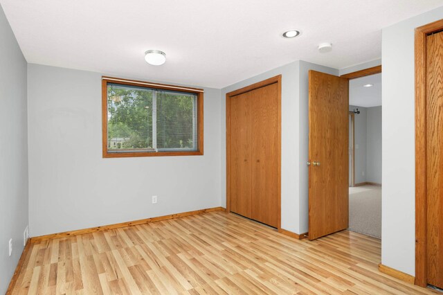 1110 Lilac Ct, Waconia, MN 55387 - unfurnished bedroom with light wood-style flooring, a closet, and recessed lighting