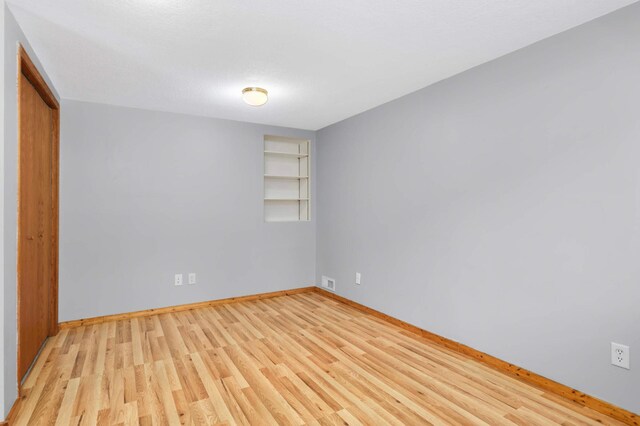 1110 Lilac Ct, Waconia, MN 55387 - unfurnished bedroom featuring light wood-type flooring and a closet