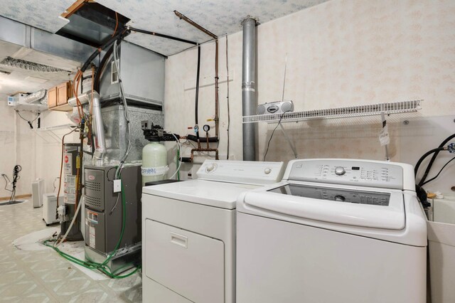 1110 Lilac Ct, Waconia, MN 55387 - laundry area with washing machine and clothes dryer, light floors, and water heater