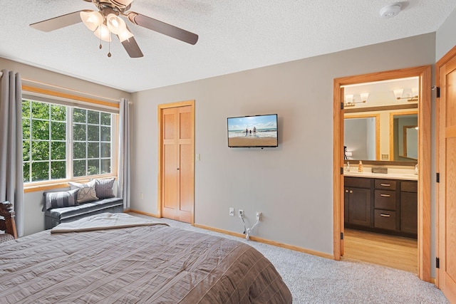 8772 Benson Way Unit 81, Inver Grove Heights, MN 55076 - bedroom featuring light colored carpet, ensuite bath, a textured ceiling, and a ceiling fan