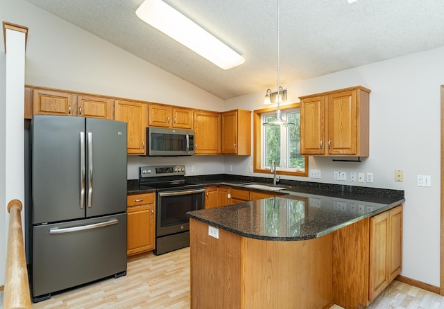 816 Bristol Ln NE, Rochester, MN 55906 - kitchen with appliances with stainless steel finishes, vaulted ceiling, a peninsula, dark stone counters, and hanging light fixtures