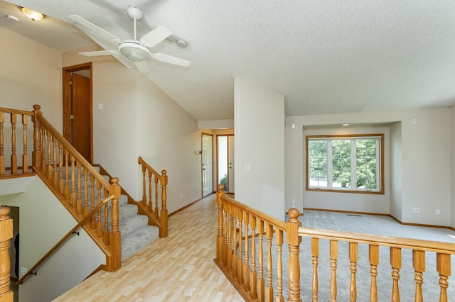 816 Bristol Ln NE, Rochester, MN 55906 - stairs featuring a textured ceiling, a ceiling fan, and wood finished floors