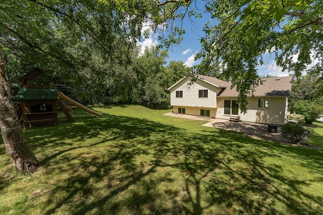 816 Bristol Ln NE, Rochester, MN 55906 - view of grassy yard with a playground and a patio